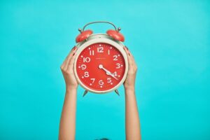 Alarm clock held by two hands