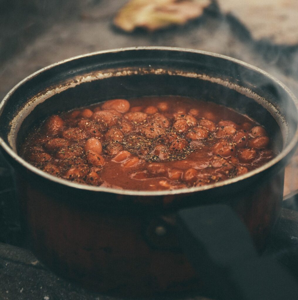 Hot baked beans in a saucepan.