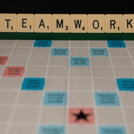 Scrabble board with lettters on stand spelling Teamwork
