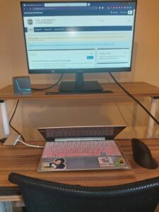 Laptop on desk with an extra screen, showing the MyEd page.