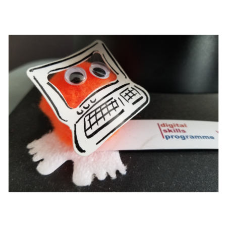Picture of a small fluffy orange toy next to a 'Digital Skills Programme' note