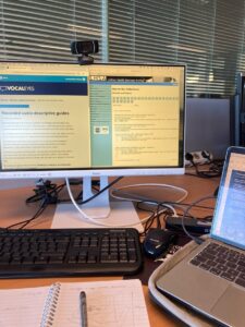 A photo of a desktop computer, displaying a draft of the audio transcript