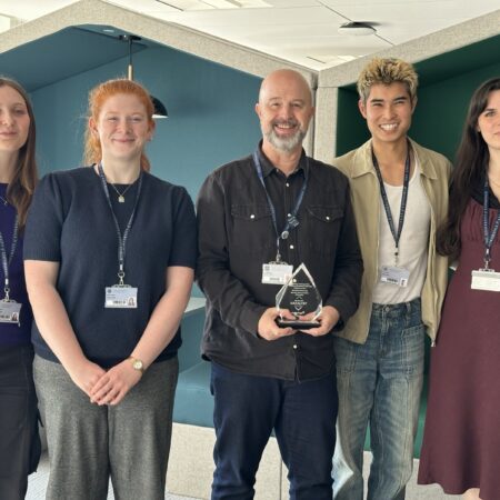 Group of Learn Foundations interns and their manager holding the Anthology Catalyst Award.
