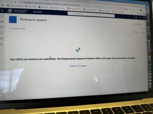 An image of my laptop screen showing that my NITS has been submitted. There is a green check on the screen