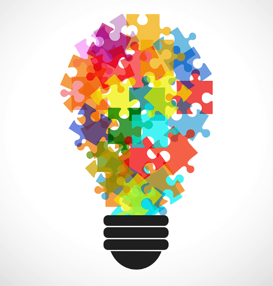 lightbulb shape created by many overlapping puzzles pieces in bright colours, with a black base. White background.