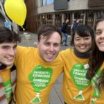 Walking tour leaders wearing yellow and green science festival t-shirts