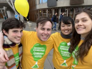 Walking tour leaders wearing yellow and green science festival t-shirts