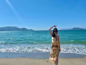 Victoria standing on the beach on a sunny day