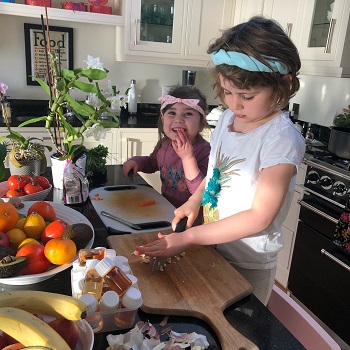 Children practising food hygiene and safety standards at home in the kitchen