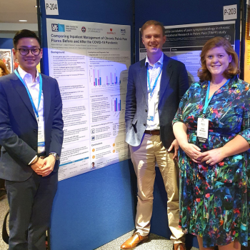 Kevin with Professor Horne and Dr Whitaker, standing beside Kevin's poster board at the world congress for endometriosis in Edinburgh