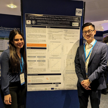 Kevin and a researcher colleague standing beside their poster board at the world congress for endometriosis in Edinburgh