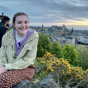 Amberley Evans in front of Edinburgh skyline in background.