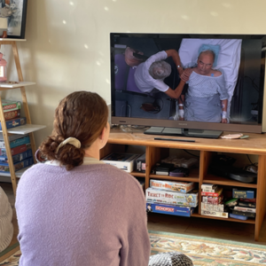 Amberley Evans watching medical documentary on TV.