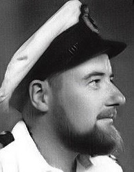 black and white image of michael's face in uniform, wearing a hat turned away from camera