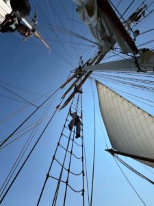 view of someone standing in sails from, taken from below them looking up