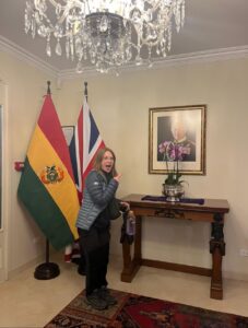 Lucy standing in front of flags in the Britsh Consulate
