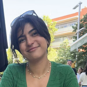 Photo of Mona smiling with building in background