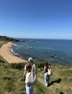Shot of students walking down to the beach