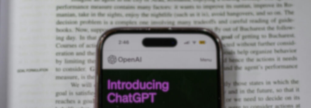 Phone with ChatGPT open on top of a textbook