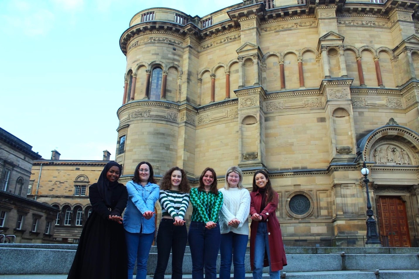 Students who founded the Saving Lives campaign standing in front of McEwan Hall