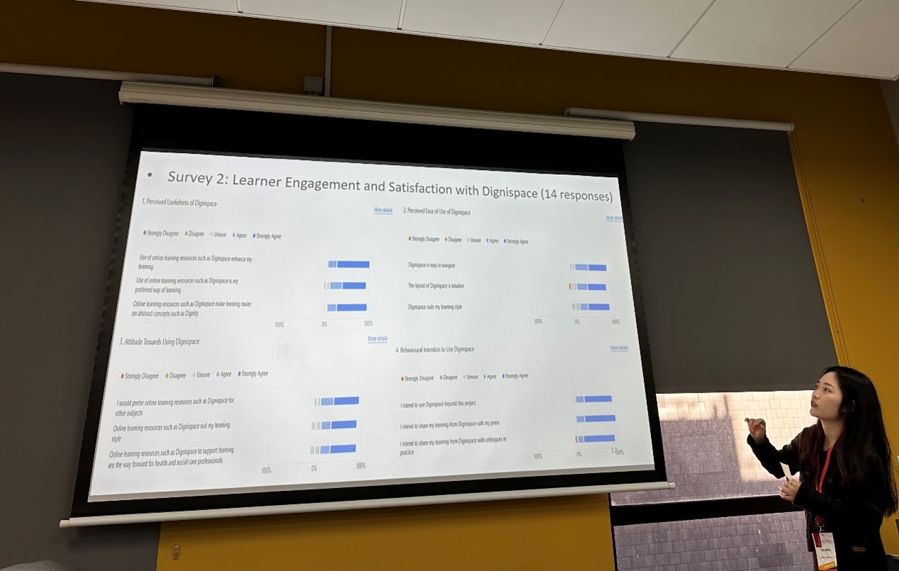Yajing Wang presenting a slide in a classroom setting