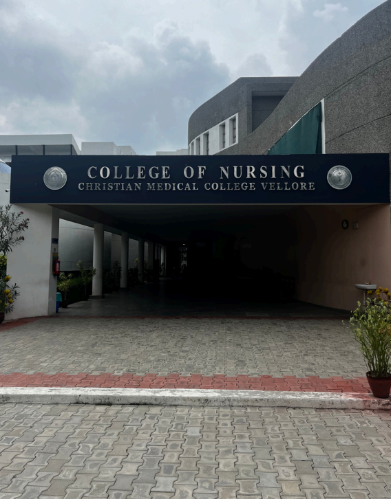 The College of Nursing building stands prominently in the center of a spacious parking lot.