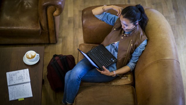 lady using laptop on sofa