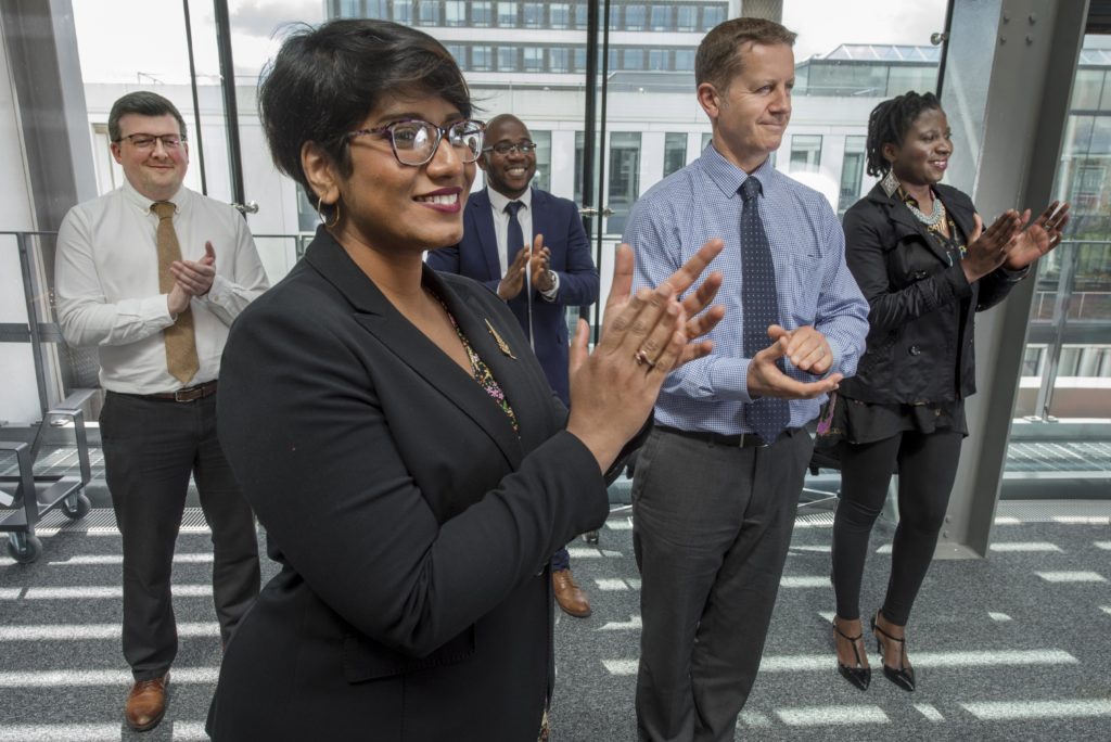 Working professionals clapping hands