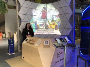 Kirsten Leggatt sitting at an event booth