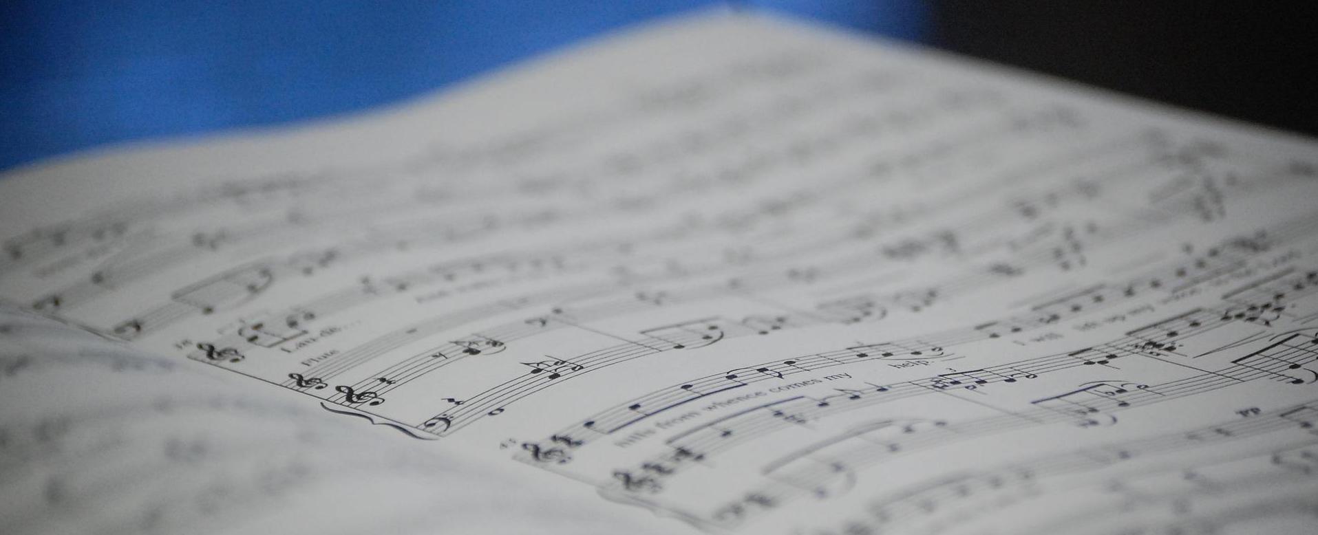 Image of sheet music against a blue background.