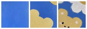 The painting process of a light brown bear and a small white flower on a blue background