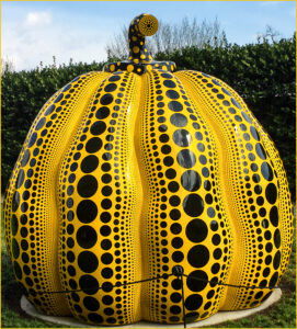 A giant pumpkin with neatly arranged polka dots on its surface.
