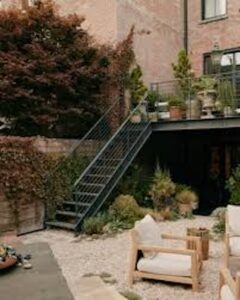 This is a gravel garden with a Mediterranean feel, using ABC Stone Renaissance Dolomite Flamed and Brushed tiles , which complement the travertine and blue marble tessellations on the terrace. They arranged the stone tiles in quadrilateral shapes and filled the centres with cobbles in mortar to avoid any instability when people sit or walk in the area. Brooke then laid thyme between the tiles to break up the monotony of the palette. The end result is a space that feels lived in and natural, while still being rooted in European sensibilities.