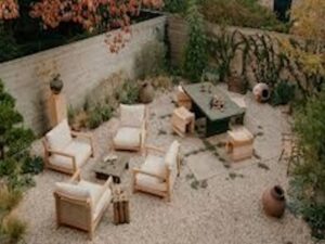 This is a gravel garden with a Mediterranean feel, using ABC Stone Renaissance Dolomite Flamed and Brushed tiles , which complement the travertine and blue marble tessellations on the terrace. They arranged the stone tiles in quadrilateral shapes and filled the centres with cobbles in mortar to avoid any instability when people sit or walk in the area. Brooke then laid thyme between the tiles to break up the monotony of the palette. The end result is a space that feels lived in and natural, while still being rooted in European sensibilities.