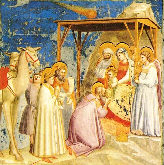 Fresco of Nativity scene with infant, figures in robes, a comet, and animals under a wooden shelter.