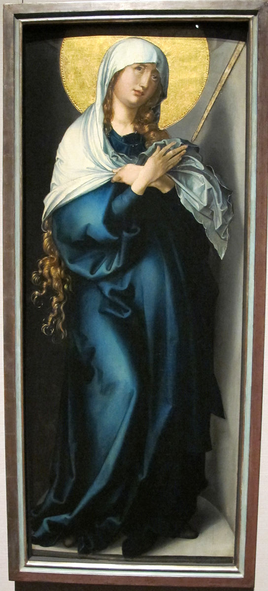 A portrait of the Virgin Mary in a blue robe with a white veil and a golden halo.