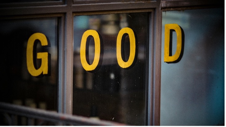 Yellow "GOOD" letters on a window, symbolizing positive feedback for shared creative work.