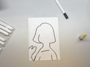 Outline of the portrait on the paper.