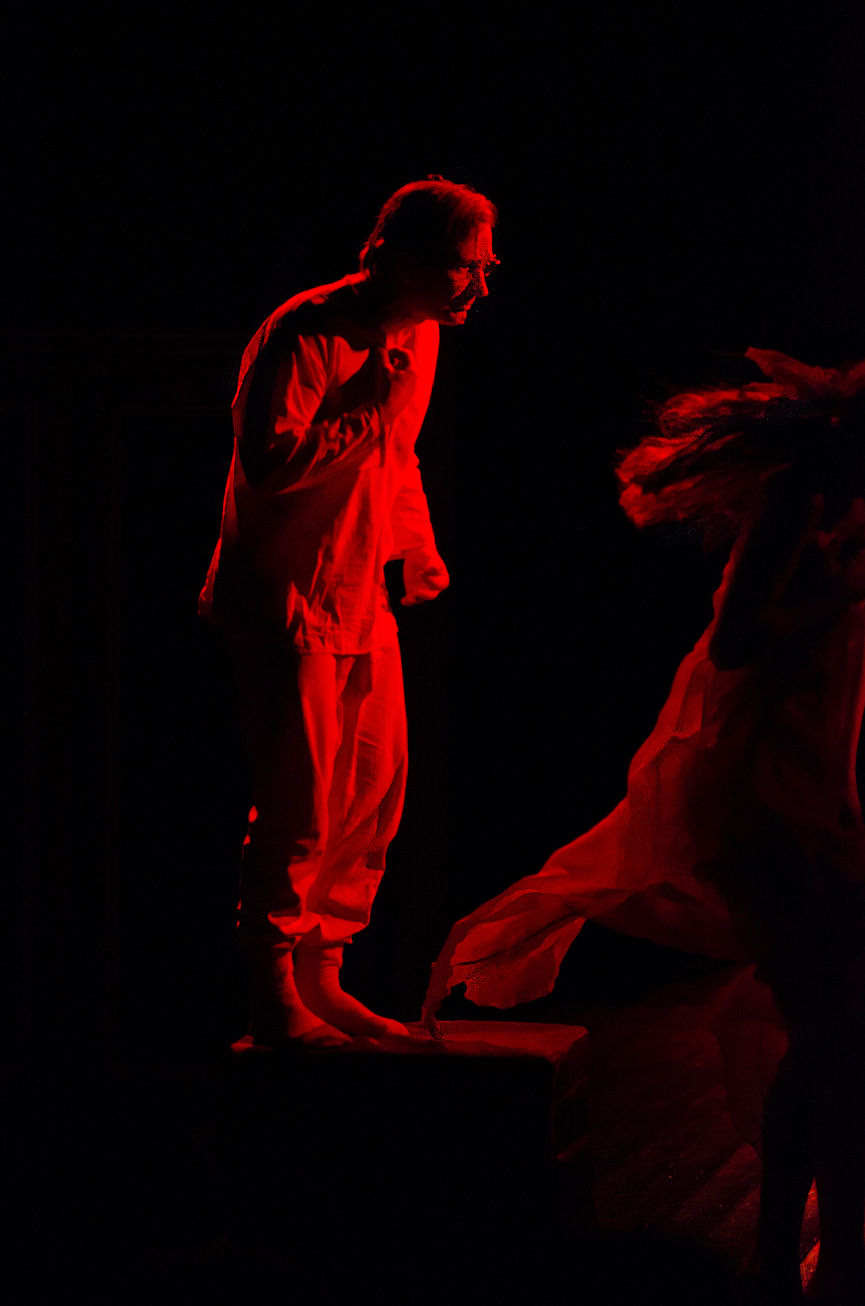 From “Cherry Orchard” Perfomance of Moscow Theatre Na Pokrovke. Chekhov Forever A middle-aged male actor, concentrated on delivering his performance, was illuminated by a wash of red stage light.