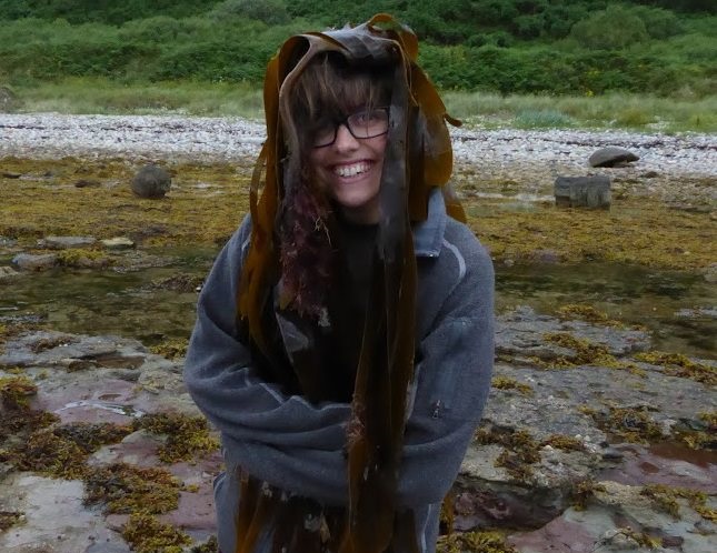Photo of Rosalyn Pearson outside surrounded by seaweed