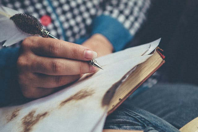 Close up of someone writing on a piece of paper.