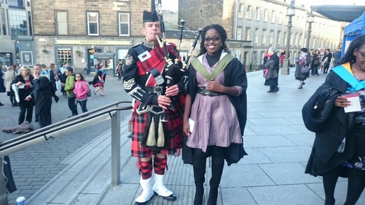 Chaona with a piper at graduation