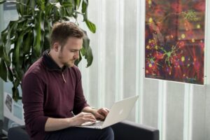 PhD student typing on a laptop