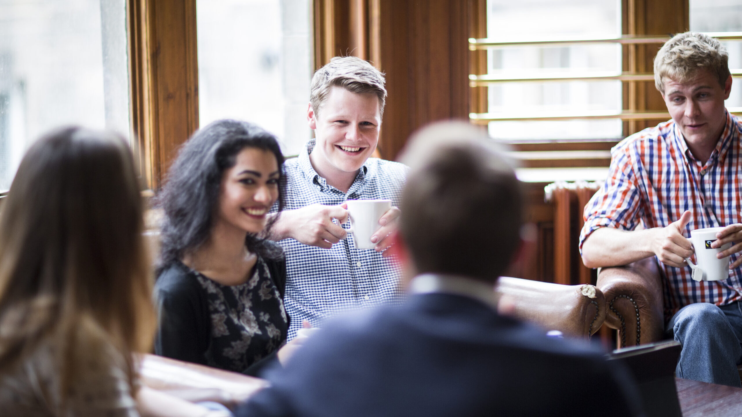 University of Edinburgh postgraduate students talking at a cafe