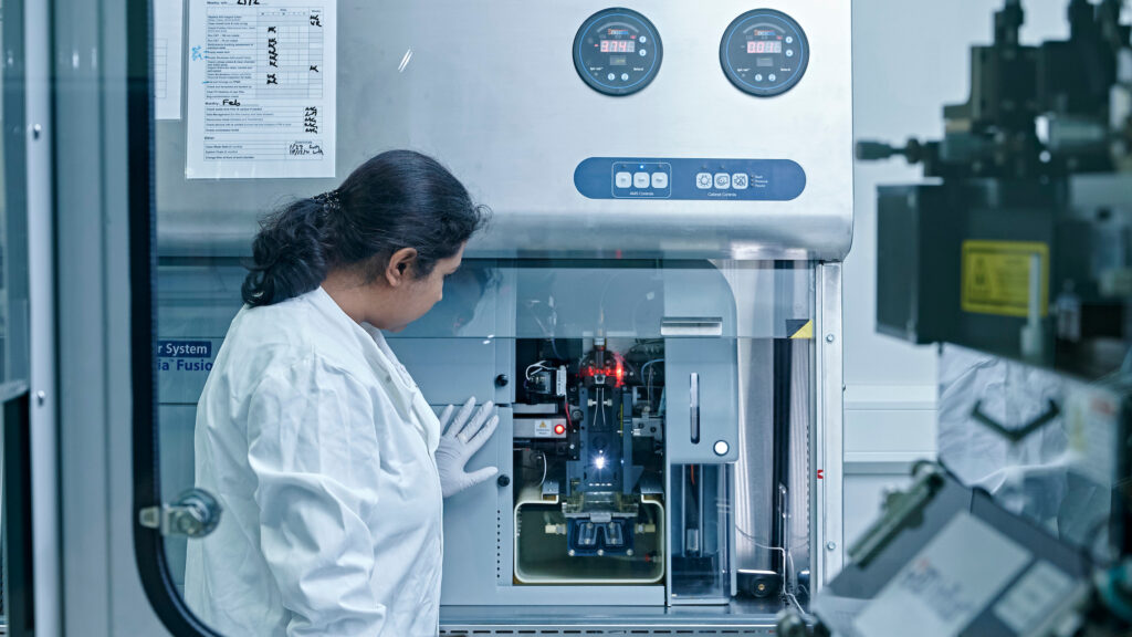 Researcher using a flow cytometry machine.