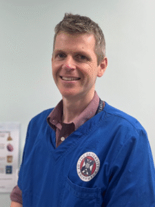 Headshot of Kevin McPeake in clinical scrubs