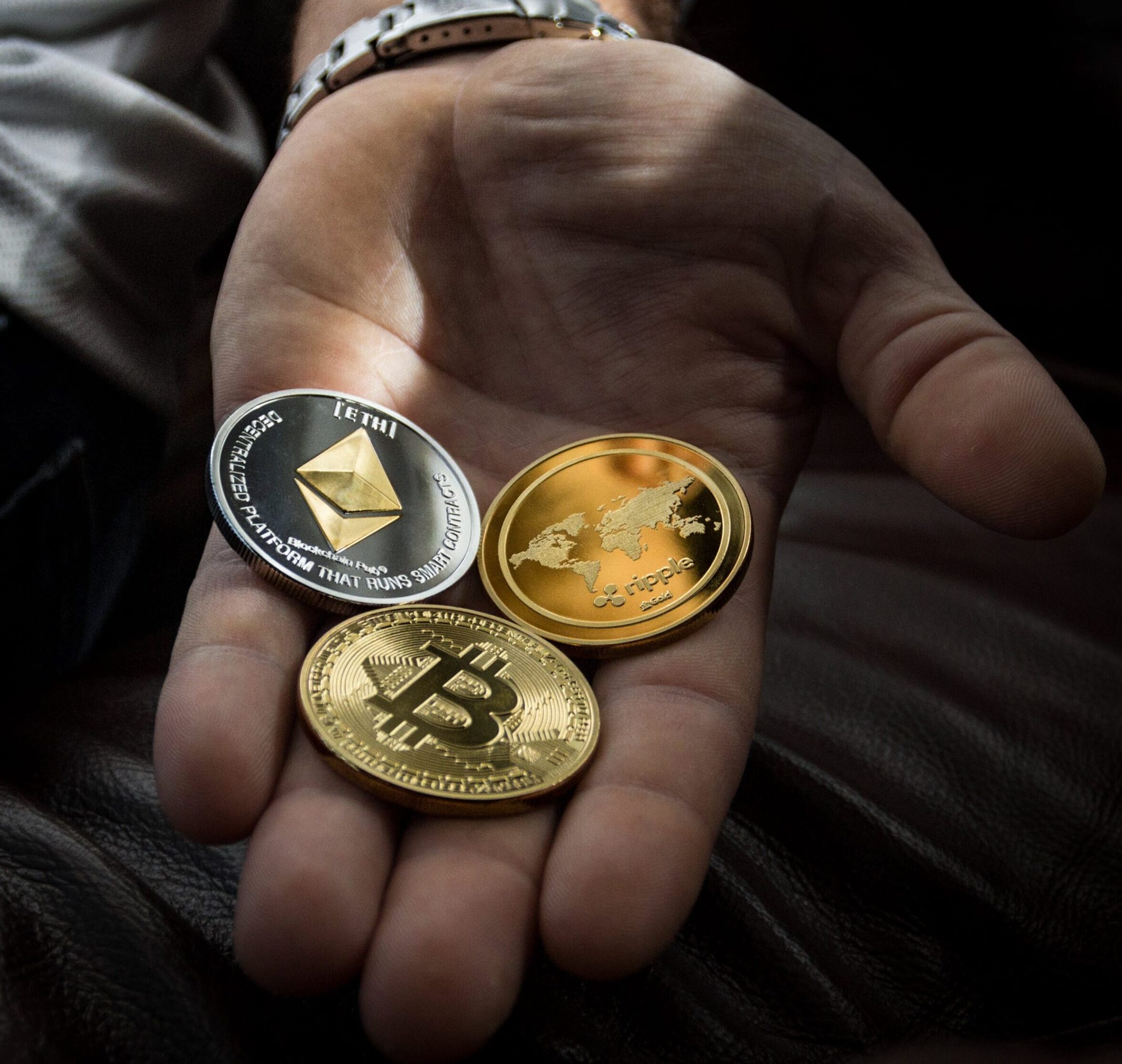 Hand with physical cryptocurrency.