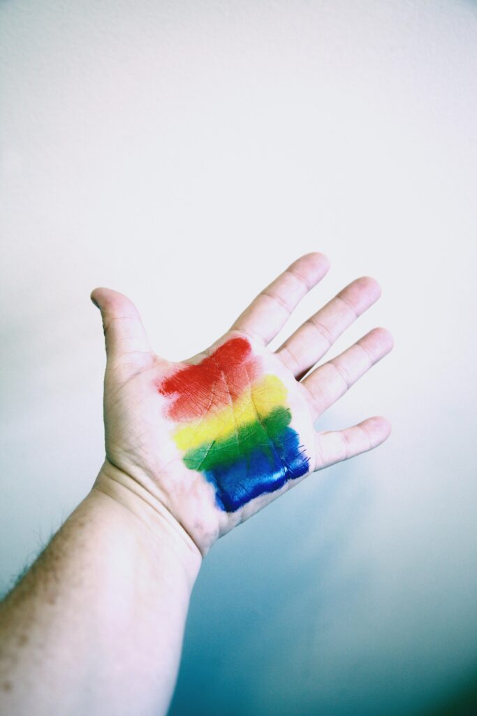 Rainbow painted on hand.