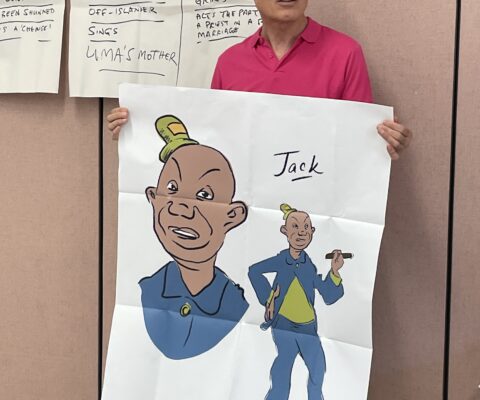 A man holding a large print of a character study of 'Jack' from Beach of Falasa