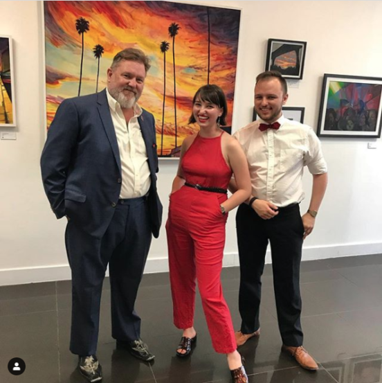 Fiona (center) with her Dad and Brother in an art gallery